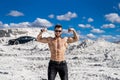 Halfnaked bodybuiler posing with muscular arms up Royalty Free Stock Photo