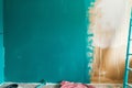 halfpainted wall with teal color, progress showing old vs new