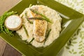 Halibut with asparagus risotto on green plate Royalty Free Stock Photo