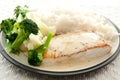 Halibut with cream sauce, boiled rice, cauliflower, and broccoli