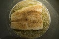 Halibut Fish baking in pan with butter