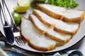 Halibut fish slices on a plate, top view