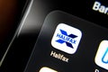 Halifax bank app seen on the edge of on the smartphone screen along with other banking apps