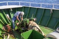 Ship worker repair anchor windlass mechanism with chain Royalty Free Stock Photo