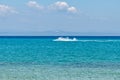 Blue sea and a jet ski floating on Aegean sea. Royalty Free Stock Photo