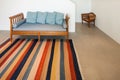 Hall with divan and striped rug Royalty Free Stock Photo