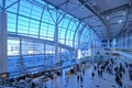 Hall of Domodedovo International Airport in Moscow, many passengers, modern architecture