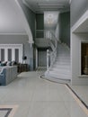 Hall entrance hall leading to a white semicircular staircase with white railings and balusters