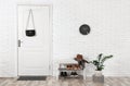 Hall interior with brick wall and white door Royalty Free Stock Photo