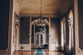 Hall of a luxury home. corridor between rooms in an antique mansion with vintage wallpaper and patterned stucco on the walls.