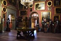 Hall with round table and chandelier and eight knights with ancient armours in the historic Stibbert villa in Florence.