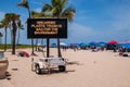 Mobile sign on beach saying, discarded plastic trash is bad for the environment