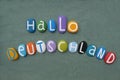 Hallo Deutschland, creative logo composed with hand painted multi colored stone letters