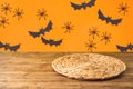 Halloweeen background with empty wooden table and wicker round placemat