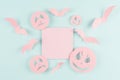 Halloween advertising mock up - pink blank sale card with soar bats and funny scary monsters faces on candy pastel green color.