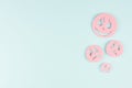 Halloween advertising mock up - pink soar scary zombie faces on candy pastel mint green background, copy space.