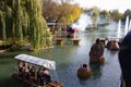 Halloween at the amusement park - water attraction: people float on wooden rafts on the river with monsters