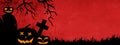 HALLOWEEN background banner template -Silhouette of scary carved luminous cartoon pumpkins, trees and cross isolated on dark red Royalty Free Stock Photo