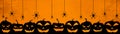 HALLOWEEN background banner wide panoramic panorama template -Silhouette of scary carved luminous cartoon pumpkins and spiders Royalty Free Stock Photo