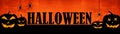 HALLOWEEN background banner wide panoramic panorama template -Silhouette of scary carved luminous cartoon pumpkins and spiders Royalty Free Stock Photo