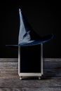 The chalkboard on the stand with Halloween Witch hat on wooden f Royalty Free Stock Photo