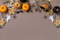 Halloween background with decorations from pumpkins, bats, spider web and ghosts top view. Happy halloween greeting card Royalty Free Stock Photo