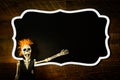 Halloween background with a funny  skeleton in front of  a blank chalkboard Royalty Free Stock Photo