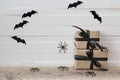 Halloween background with gifts boxes, decorative spiders and ba