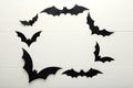 Halloween background with paper bats on white wooden background. Frame. Halloween holiday decorations. Flat lay, top view, copy