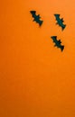 Halloween background, paper black bats on orange background, vertical background Royalty Free Stock Photo