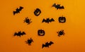 Halloween background, paper black bats, pumpkins and spiders on orange background Royalty Free Stock Photo