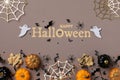 Halloween background with party decorations from pumpkins, bats, spider web and ghosts top view. Holiday greeting card Royalty Free Stock Photo