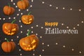 Halloween background with pumpkins and jack o lantern on wood with fairy lights