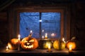 Halloween background, pumpkins stand in a row against the background of a barn window Royalty Free Stock Photo