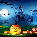 Halloween background with scary pumpkins candles in the graveyard at night with a castle background Royalty Free Stock Photo
