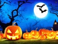 Halloween background with scary pumpkins candles in the graveyard at night with a castle background Royalty Free Stock Photo
