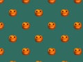 Halloween background seamless diagonal pattern from bright orange carved pumpkins with Jack o lantern faces on dark green