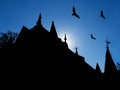 Halloween background with silhouettes of castle roofs with weathervanes and flying bats Royalty Free Stock Photo