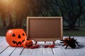 Halloween background. Spooky pumpkin, chalkboard on wooden floor Royalty Free Stock Photo