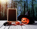 Halloween background. Spooky pumpkin, chalkboard on wooden floor Royalty Free Stock Photo