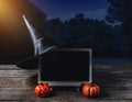 Halloween background. Spooky pumpkin, Witch hat, chalkboard on w Royalty Free Stock Photo