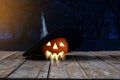 Halloween background. Spooky pumpkin, Witch hat on wooden floor