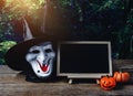 Halloween background. Spooky pumpkin, Witch mask, chalkboard on Royalty Free Stock Photo