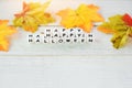 Halloween background with word blocks happy halloween decorations and leaves autumn on white wooden table holiday concept Royalty Free Stock Photo