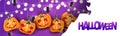 Halloween banner or website header holiday decoration with creepy scary pumpkin faces and glowing lights garland on purple backgro