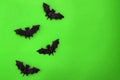 Halloween bats on green background