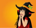 Halloween. Beautiful woman in hat and witch costume is surprised