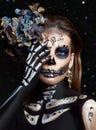 Halloween beauty portrait of a skeleton woman of death Bokeh glitter, the makeup on the face. Girl death Halloween costume. Day of Royalty Free Stock Photo