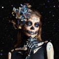Halloween beauty portrait of a skeleton woman of death Bokeh glitter, the makeup on the face. Girl death Halloween costume. Day of Royalty Free Stock Photo