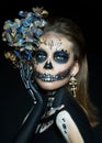 Halloween beauty portrait of a skeleton woman of death, the makeup on the face. Girl death Halloween costume. Day of The Dead. Royalty Free Stock Photo